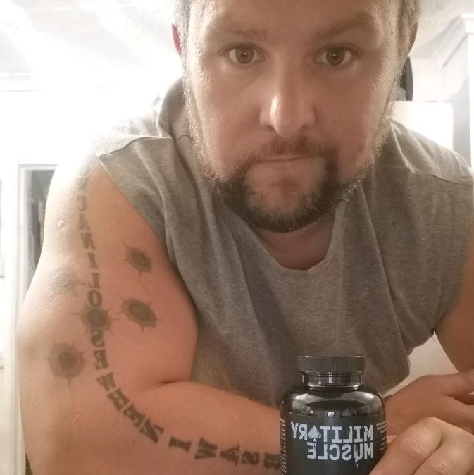 a man holding a package of military muscle testosterone booster