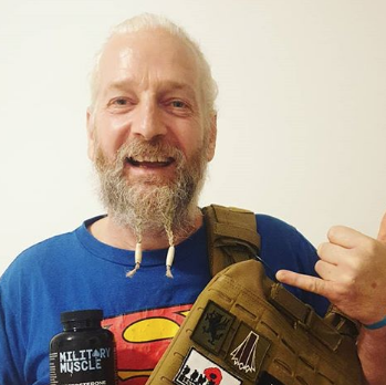 a man holding a package of military muscle 
